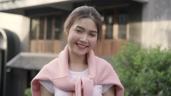 Asian woman feeling happy smiling to camera while traveling at Chinatown in Beijing, China. alt