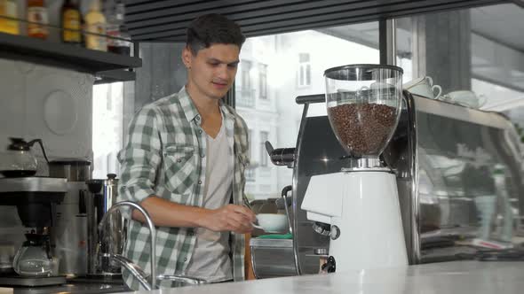 Handsome Male Barista Smiling To the Camera After Serving Delicious Coffee