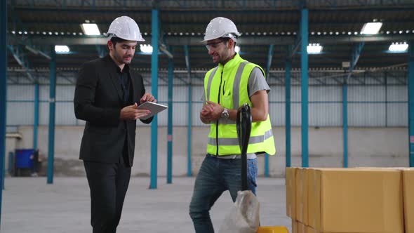 Factory Workers Deliver Boxes Package on a Pushing Trolley in the Warehouse alt