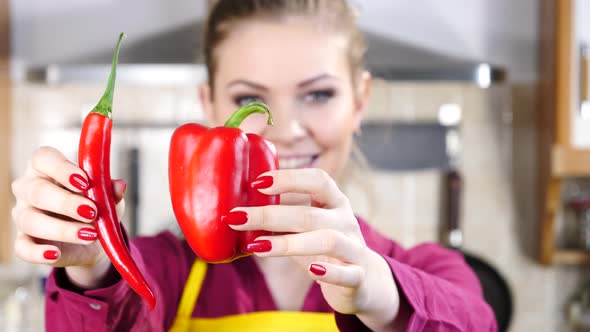 Woman Shows Chilli and Bell Pepper