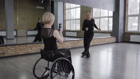Disabled Woman Shooting Live Stream of Ball Dance alt
