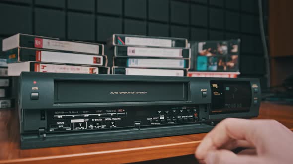 Insert VHS Cassette Into VCR and Push Play Button alt