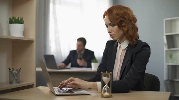 Female Company Worker Typing on Laptop, Hourglass Trickling, Devotion to Work alt