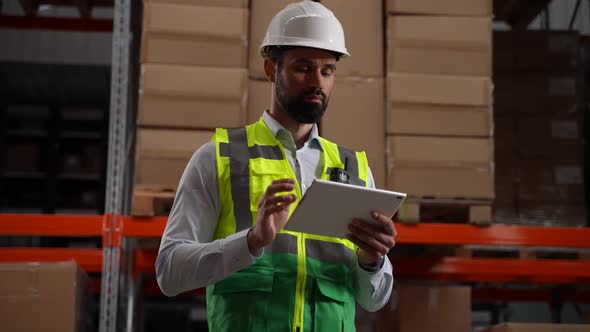 Inventory Manager Working on Tablet in Storehouse alt