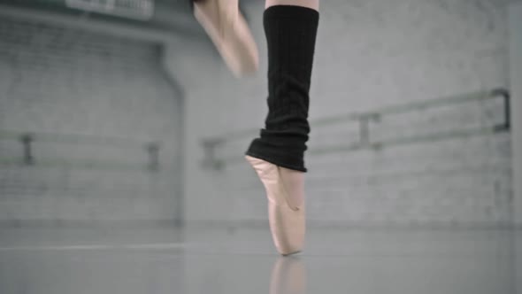 Closeup of Ballerina Feet in Pointe Shoes and Black Dress Dancing Ballet Elements Slow Motion