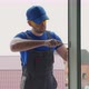 Worker Fixes Fastening for Window with Screwdriver Outside - VideoHive Item for Sale