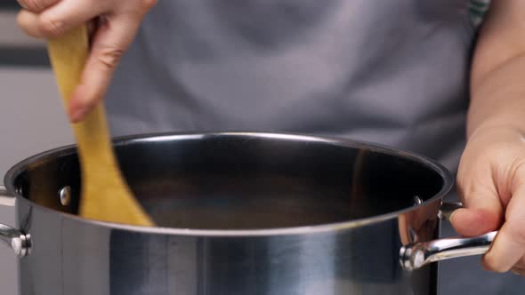 Unrecognizable Woman Cooking on Kitchen alt