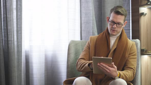 Businessman Sitting on Comfortable Couch Using Pc Tablet