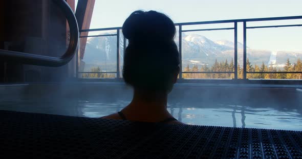 Woman relaxing in swimming pool alt
