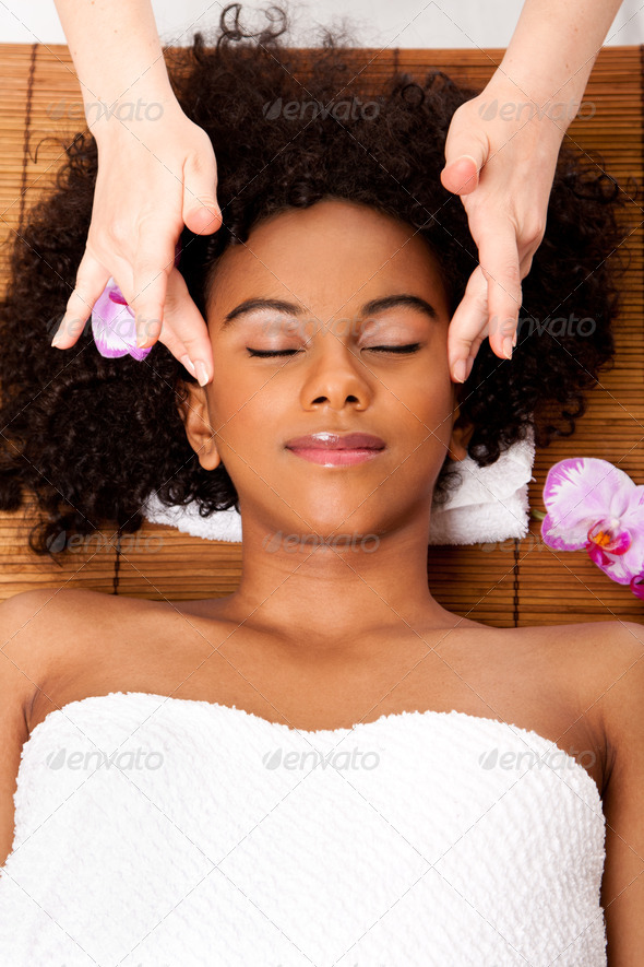 Facial temple massage in beauty spa - Stock Photo - Images