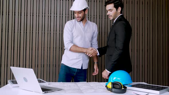 Project engineer and Businessman handshake greeting, congratulate when dealing work to successful