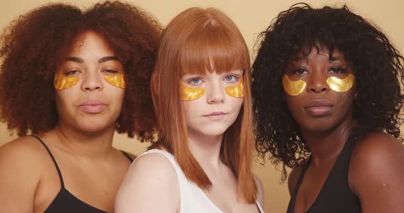 Girl Friends of Different Races Pose with Eye Patches alt