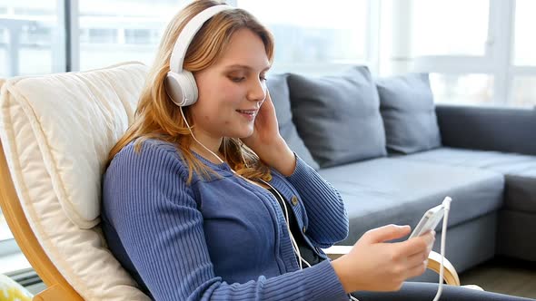 Woman listening music on mobile phone alt