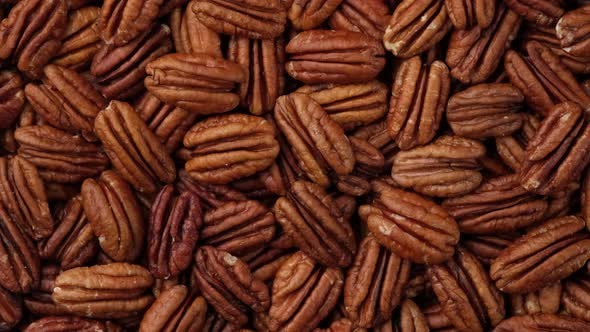 pecan nuts top view, rotation. Healthy food concept. 4K UHD video alt