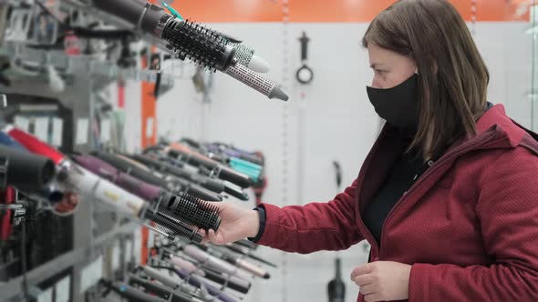 Girl in Medical Mask Buys Hair Dryer in Shop