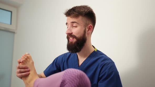 Therapist Doing Healing Treatment on Female Leg Knee alt
