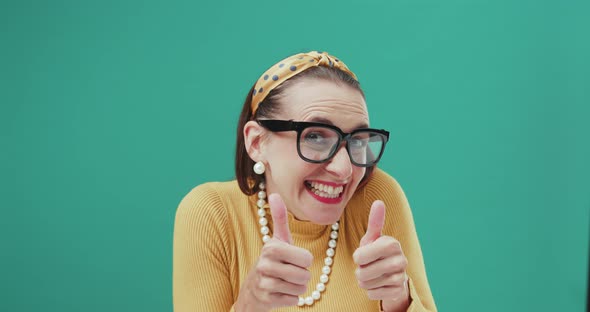 Cheerful vintage style woman giving a thumbs up