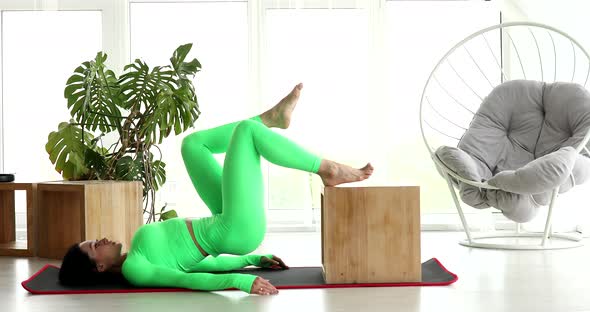 Young woman doing sports, fitness at home.