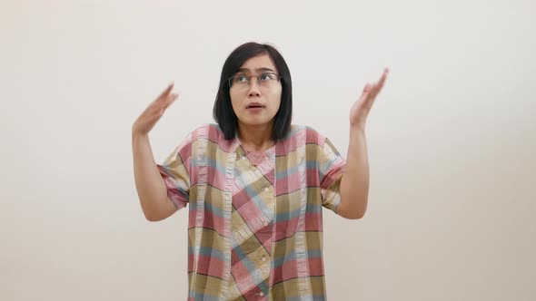Pretty asian woman pointing fingers left and right, making decision, showing two variants choices alt