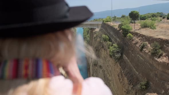 Woman Looking at Corinth Canal alt