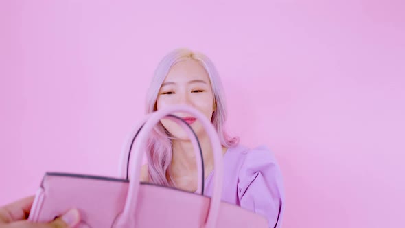 Asian woman smiling happy after surprise happy birth day handbag gift from her boyfriend alt