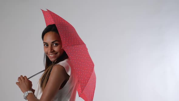 Attractive African Model Posing with Umbrella for a Fashion Magazine Photo Shoot alt