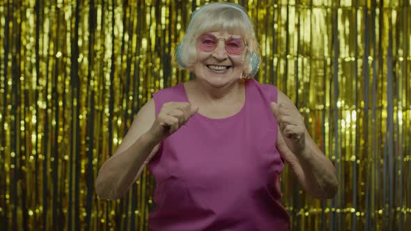 Senior Old Woman Dances, Listens Music on Headphones. Relaxing, Enjoying, Having Fun, Smiling alt