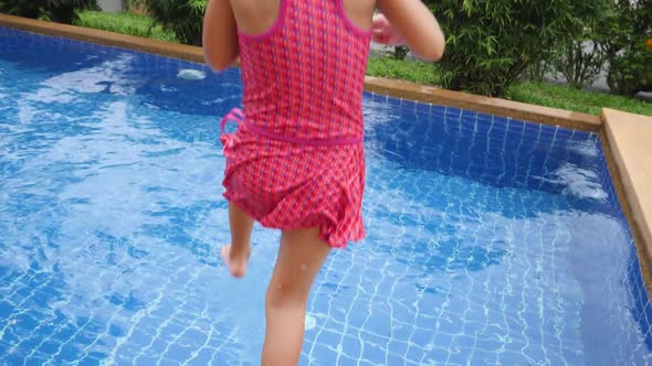 Female Child Jump and Swim in Swimming Pool