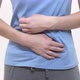 White Woman Puts Her Hands on Her Stomach and Squeezes - VideoHive Item for Sale