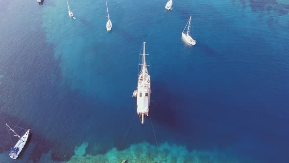 Luxury Yacht Anchored in Bay with Crystal Clear Turquoise Sea alt