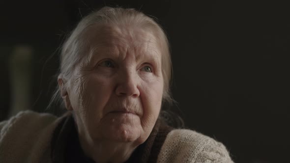 Senior Woman Sitting Indoor with Soft Window Light alt