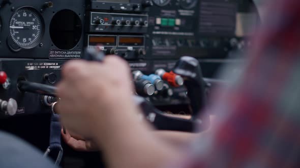 Pilot Starting Airplane Engine Using Key Sitting in Modern Plane Cabin Closeup alt