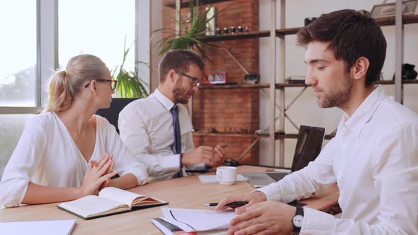 Succesful Caucasian Male Boss Sitting at Table with Female Secretary Giving His Card to Office Man alt