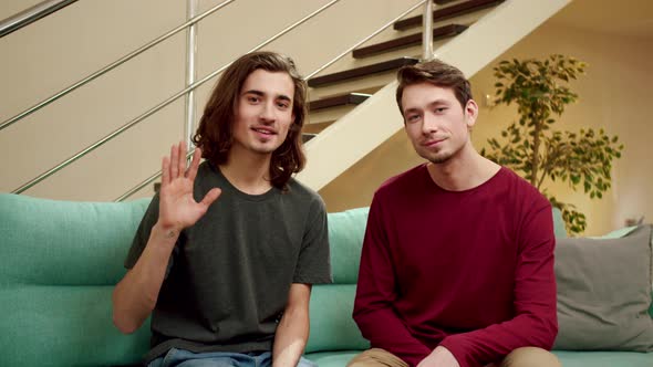 Lovers are Looking at the Camera and Waving Their Hands alt