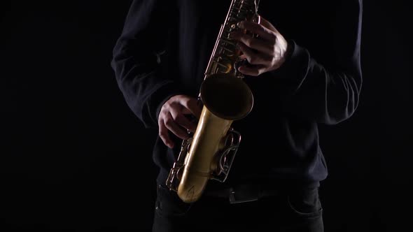 Blues on the Saxophone. Musician Playing Solo in Black Studio alt