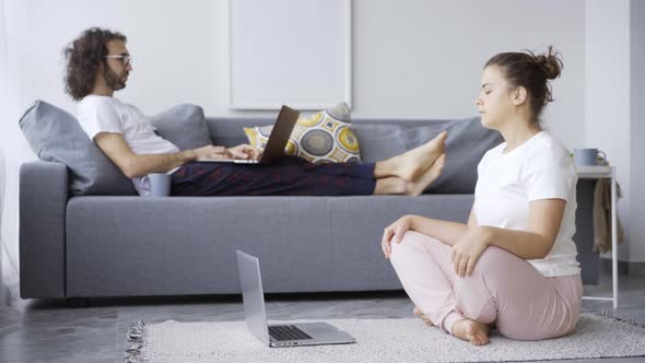 Young Brunette Stretches Neck Against Guy Typing at Home