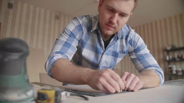 Carpenter Makes Pencil Markings on the Blank with the Help of a Ruler