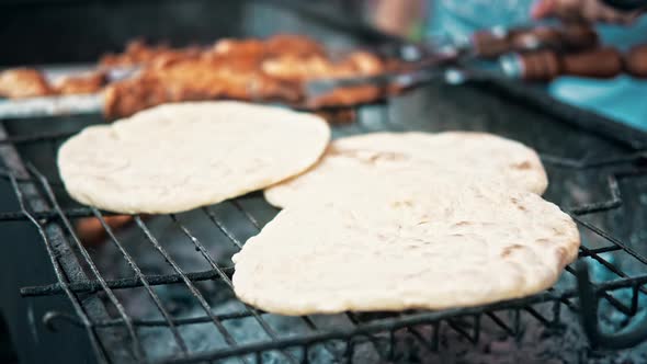 Flatbreads frying on a grill at food festival alt