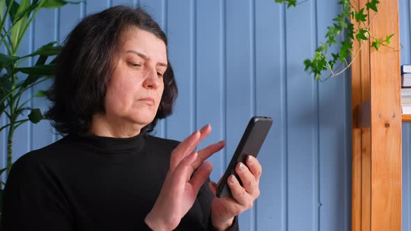Middle Aged Woman Holding Smartphone Using Mobile App