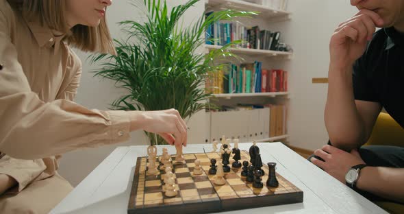 Clever Man and Woman Play Chess Game at Home