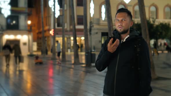 Man Voice Recognition with Smart Phone in Park Night Hotel Bar Outdoor Student Male Use Message alt