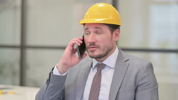 Portrait of Middle Aged Engineer Talking on Phone alt