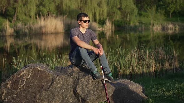 Blind Man with a Cane Sitting on the Rock alt