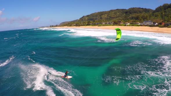 Aerial view of a man kitesurfing in Hawaii. alt