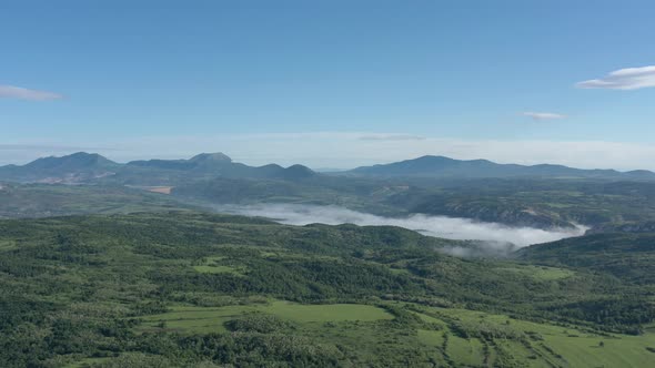 Fog over the foothills of Velik Krs Stol and Deli Jovan mountains 4K aerial video alt