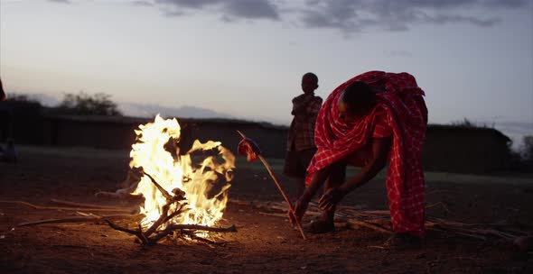 Man preparing meat at the fire alt