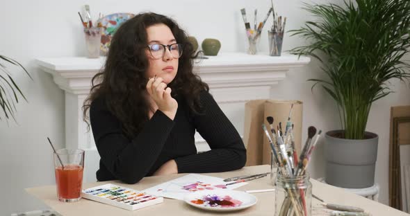 Portrait of Girl Artist Working in Her Art Workshop She is Dreaming Pensive