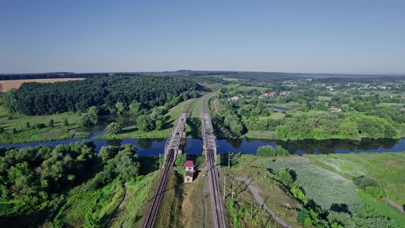 Train Bridge Crossing a River on a Bright Day alt