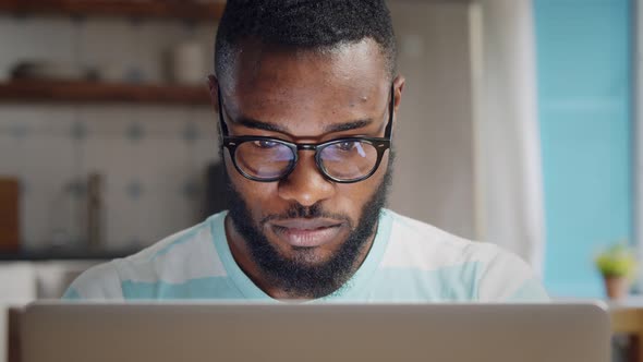 Afro-american Young Businessman Using Laptop at Home. alt