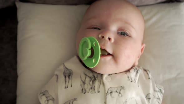 Baby Lies on Her Back and Spits Out Soother